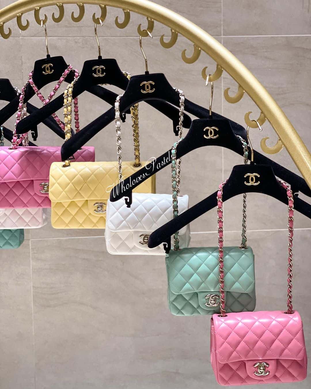 Chanel colorful bags hanging on Chanel hangers