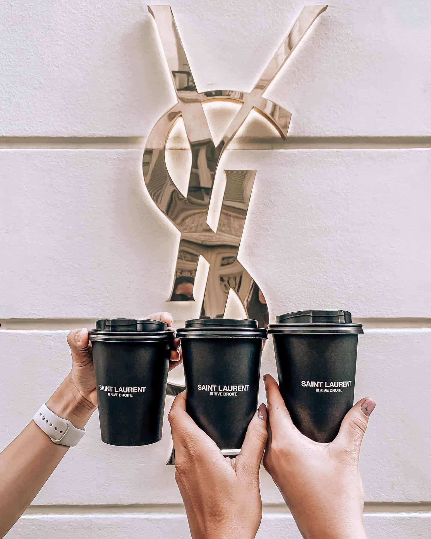 Drinking Coffee in Front of the YSL Logo in Paris