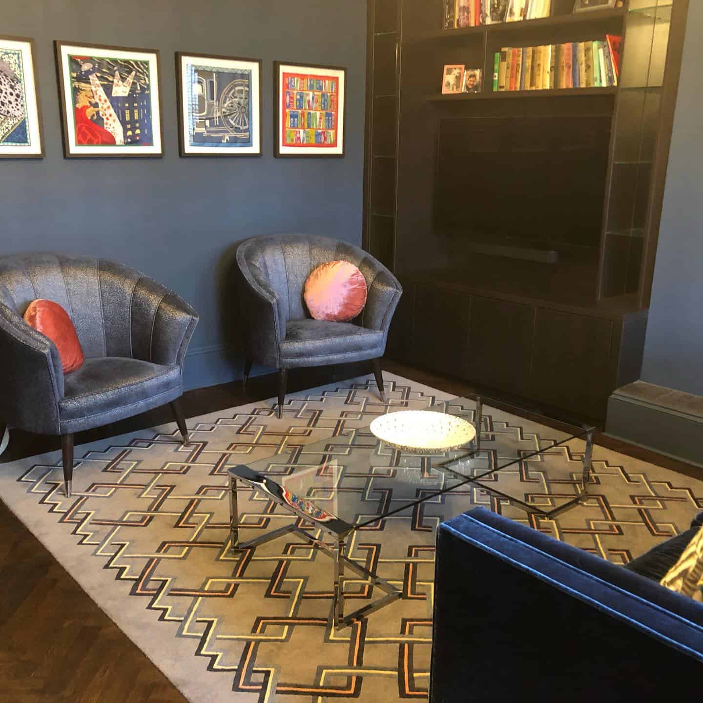 Several framed Hermes Scarves in sitting room
