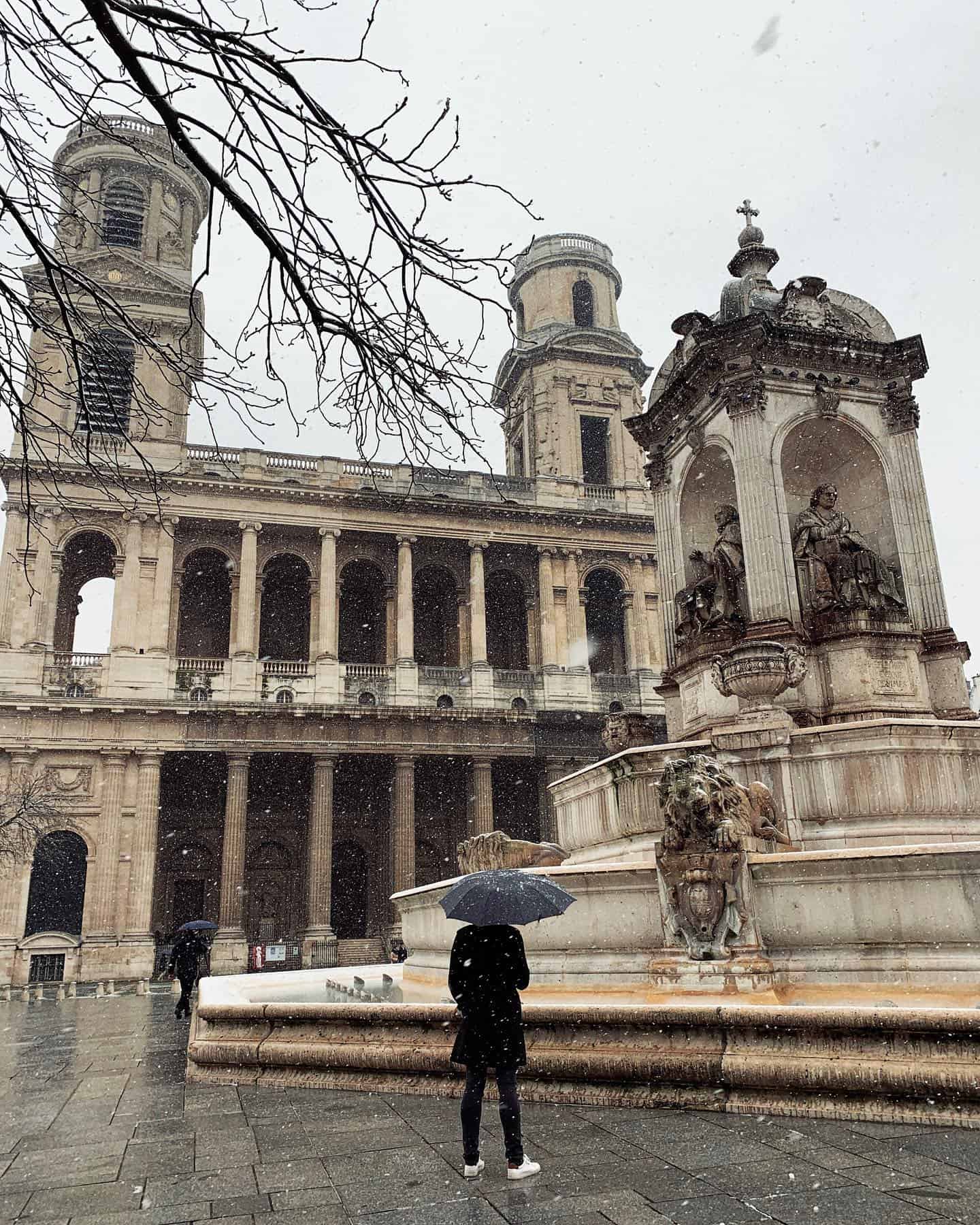 Admiring the snow in Paris at Place Saint-Sulpice